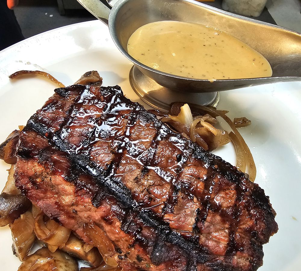 Chargrilled steak with sautéed onions, mushrooms and peppercorn sauce at Sizzlin' Smokehouse