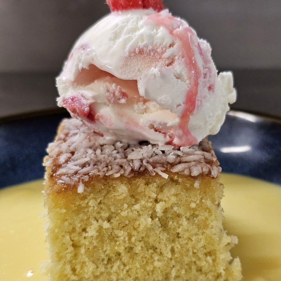 Jam and coconut sponge with ice cream and custard